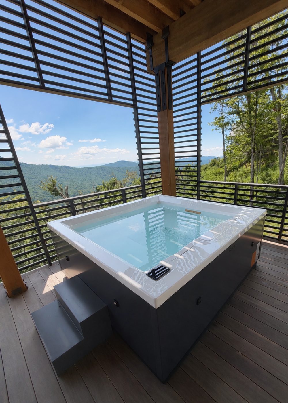 Square hot tub under a louvered pergola overlooking Blue Ridge ridgelines in the North Carolina High Country